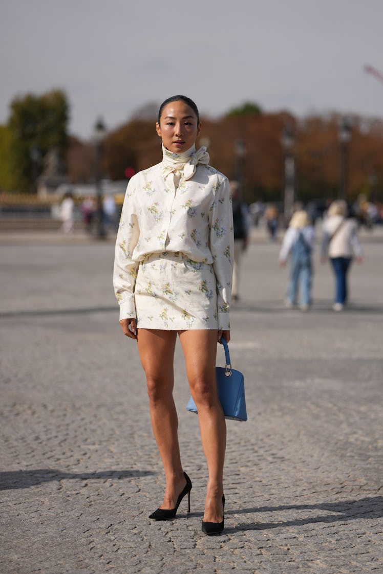 PARIS, FRANCE - OCTOBER 01:  Greta Lee wears hair pulled back into a low sleek bun, dark brown, a bl...