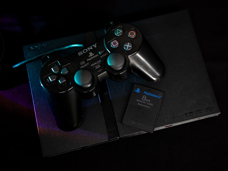 A Sony PlayStation 2 slim video game console with its controller and a memory card. (Photo by Nikos ...