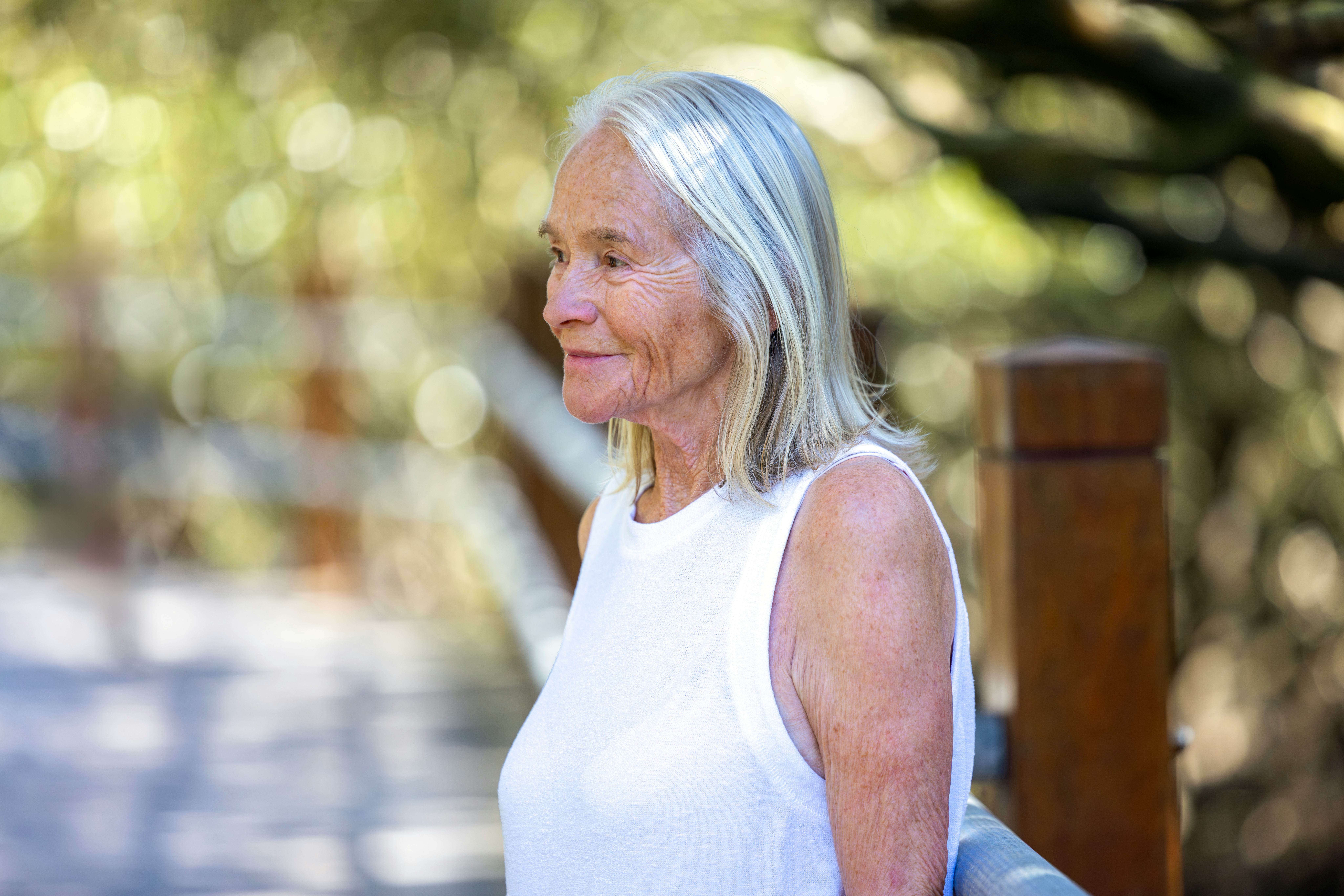 Portrait of happy, beautiful senior woman outdoor, background with copy space, full frame horizontal...