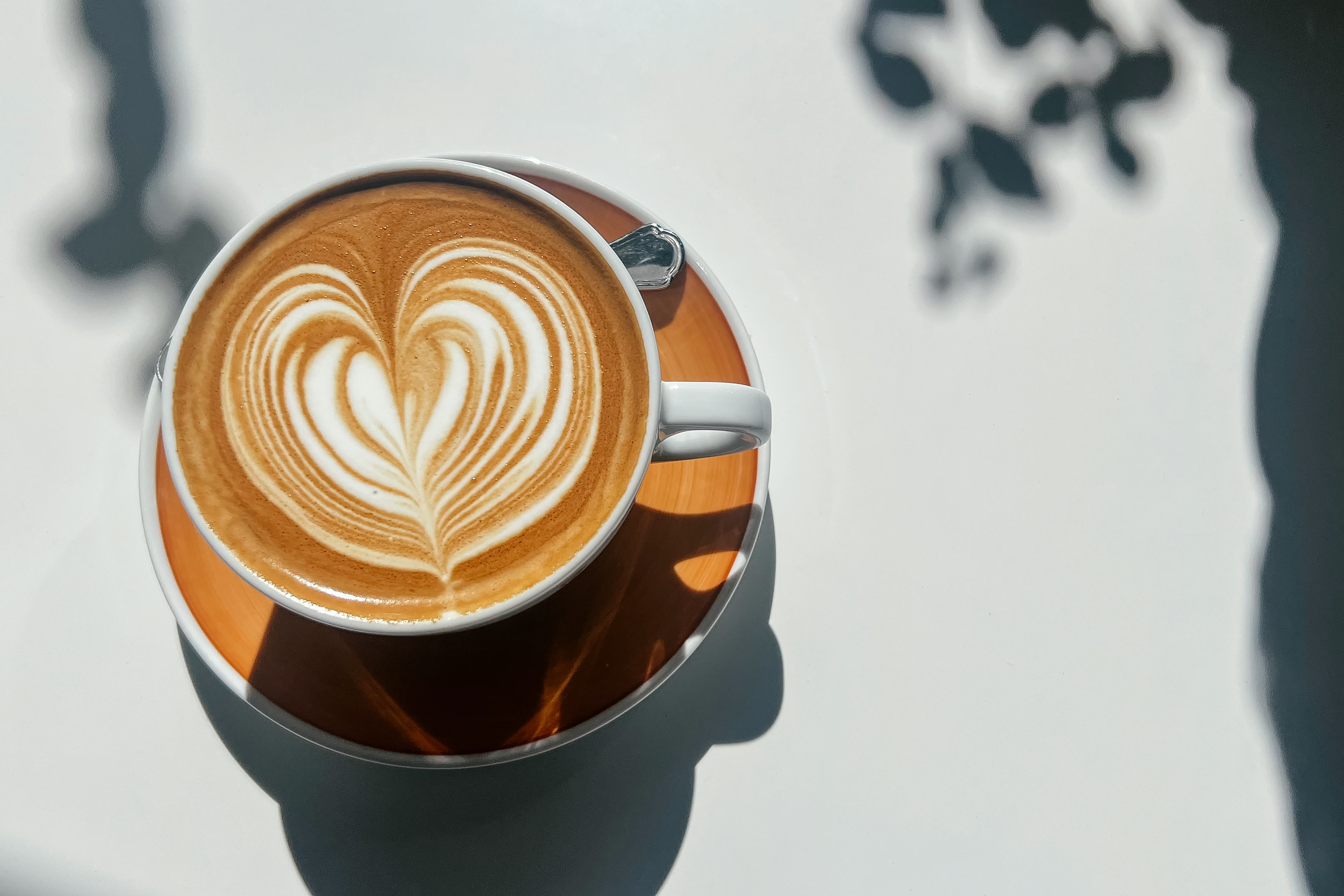 Small Business And Coffee Culture. Cup Of Flat White Coffee With Latte Art Design At The Local Sidew...