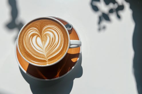 Small Business And Coffee Culture. Cup Of Flat White Coffee With Latte Art Design At The Local Sidew...