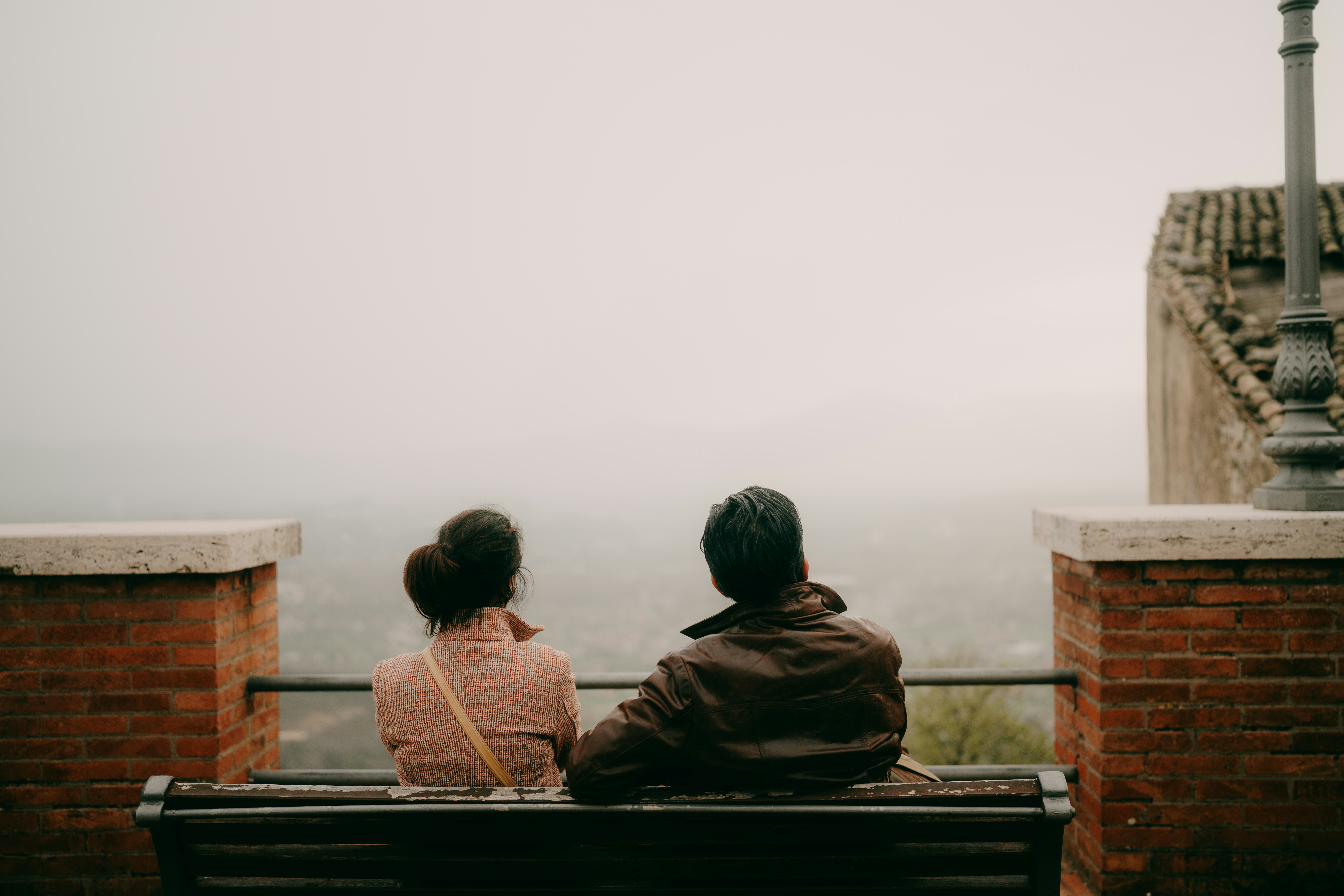 Couple sitting on bench in Italian hilltop village, Veroli, Lazio