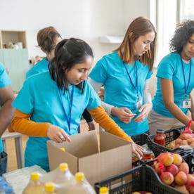 Volunteers sorting and packing food donations at a community center