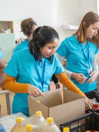 Volunteers sorting and packing food donations at a community center