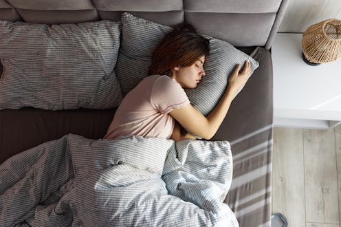 High angle view of carefree woman taking a nap in her bed.