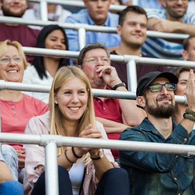 Two creative parents cheer on their athletic kid.