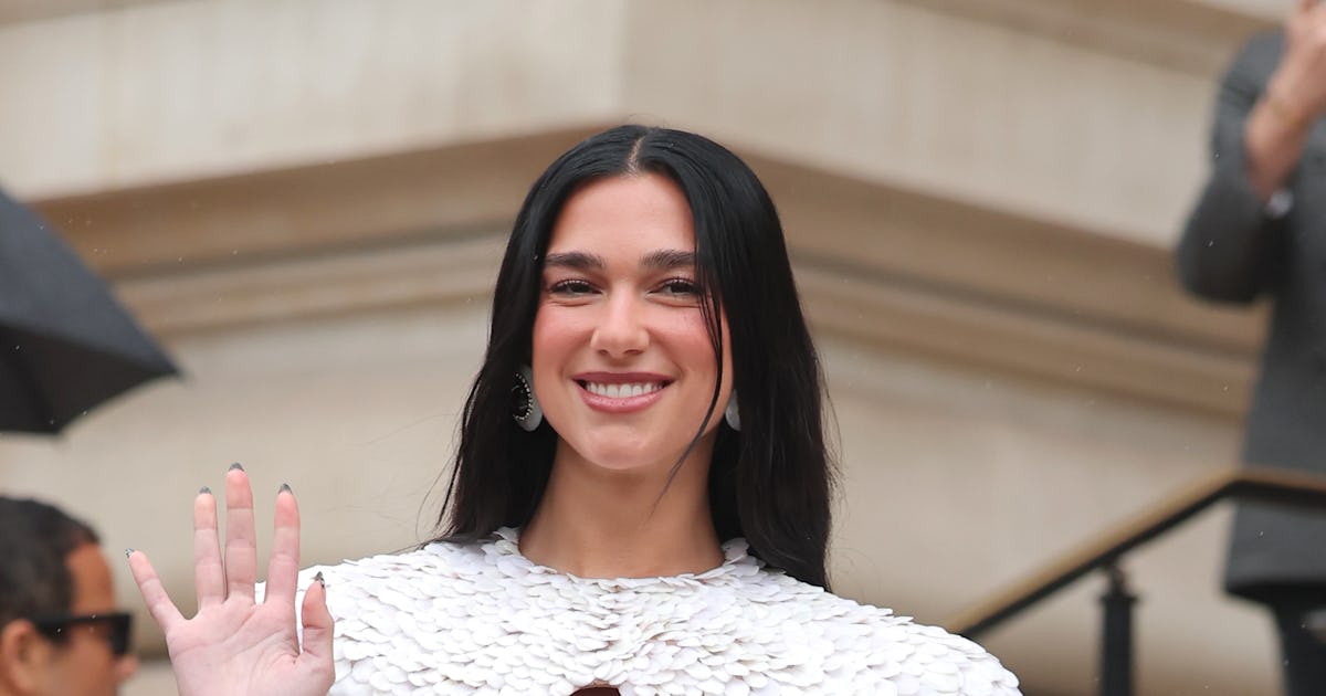 Dua Lipa Went Pantless In A Teeny Onesie To Debut Her New Skin Care Line