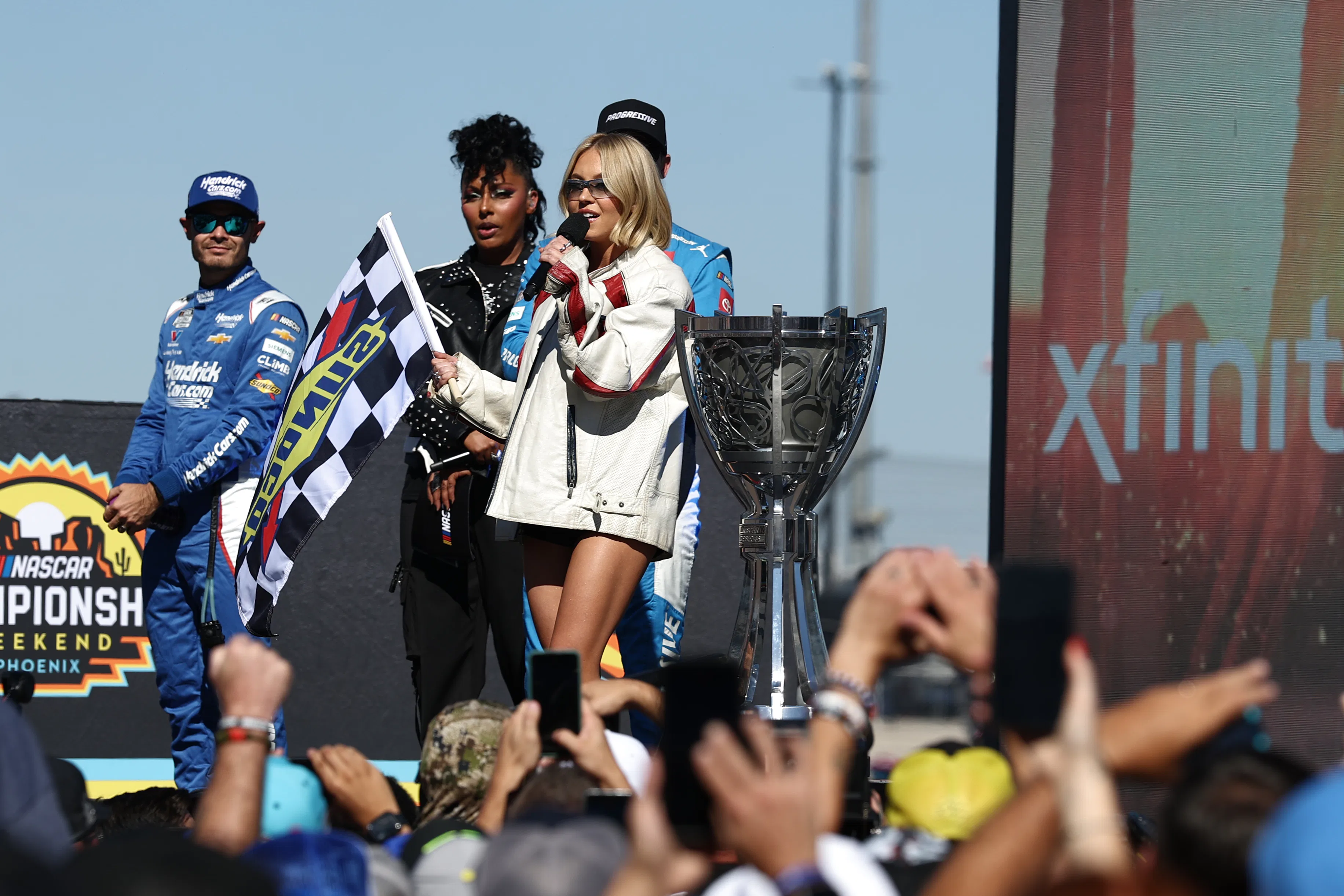AVONDALE, ARIZONA - NOVEMBER 02: Sydney Sweeney speaks onstage during pre-race ceremonies prior to t...