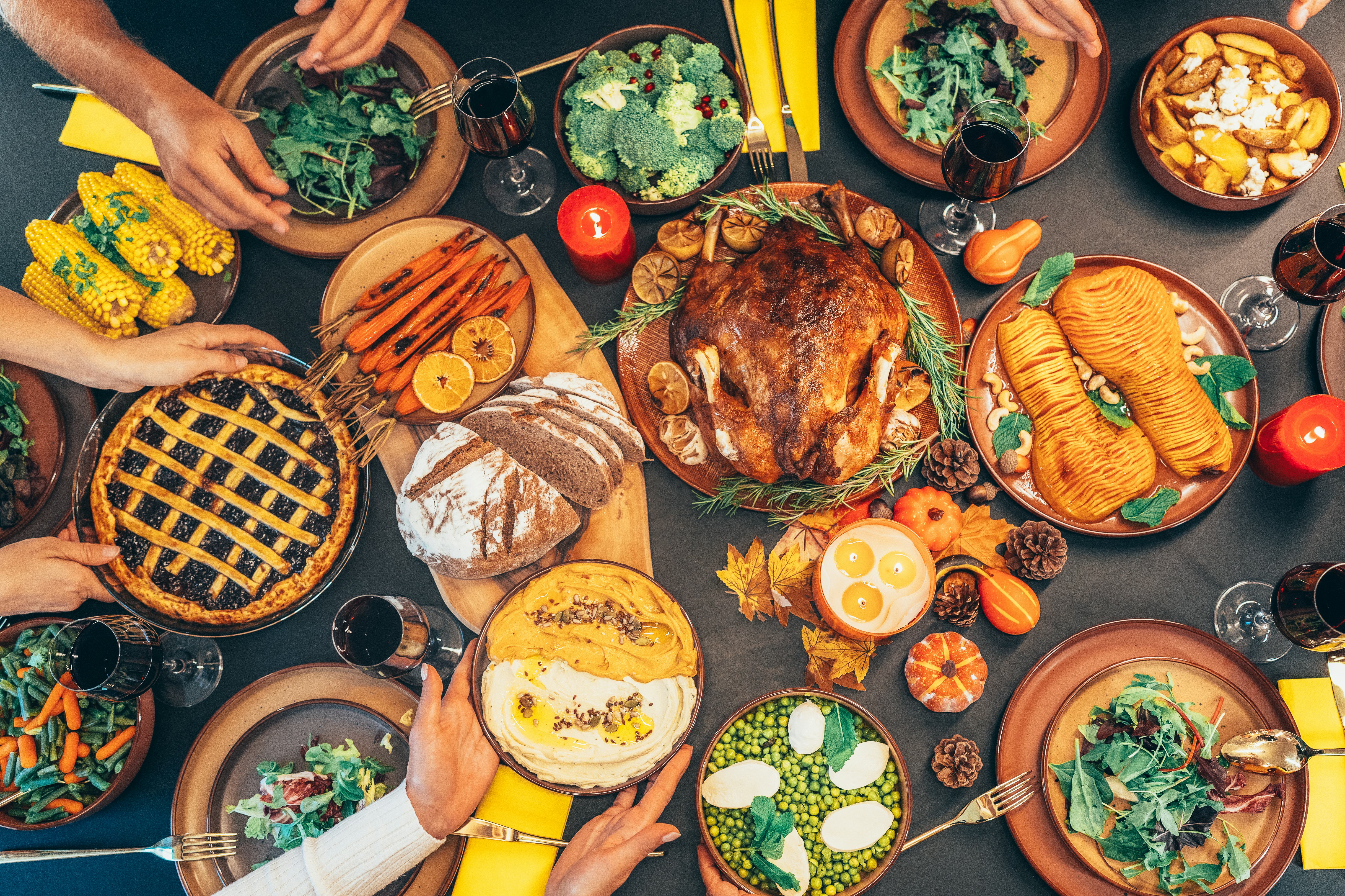 Directly above shot of festive table with roasted turkey on it. Family celebrating Thanksgiving day....