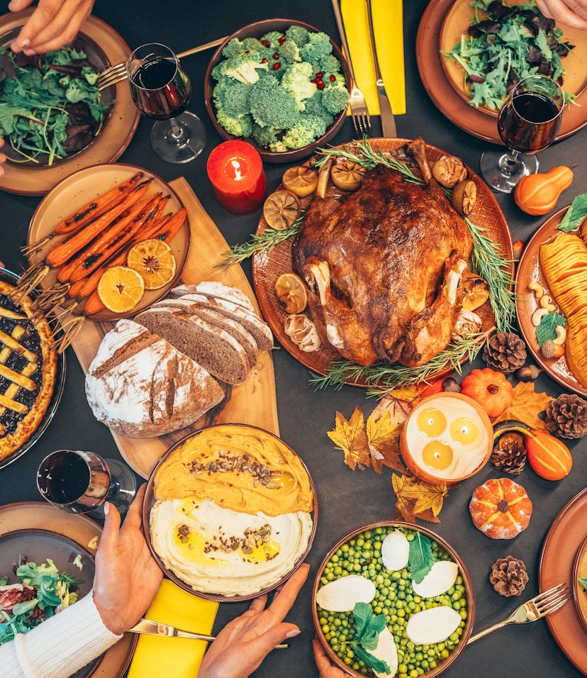 Directly above shot of festive table with roasted turkey on it. Family celebrating Thanksgiving day....