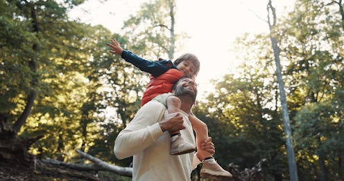 Happy dad, kid and shoulder with trees in nature for childhood, weekend or outdoor holiday. Father, ...