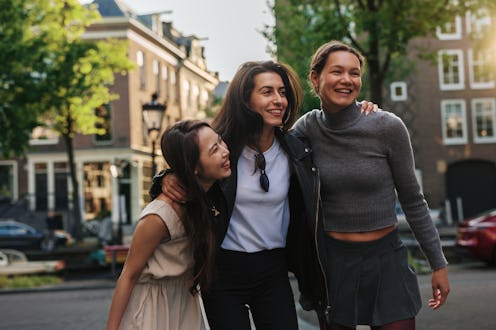 Three young female tourists are enjoying their vacation in Amsterdam, exploring the city and having ...