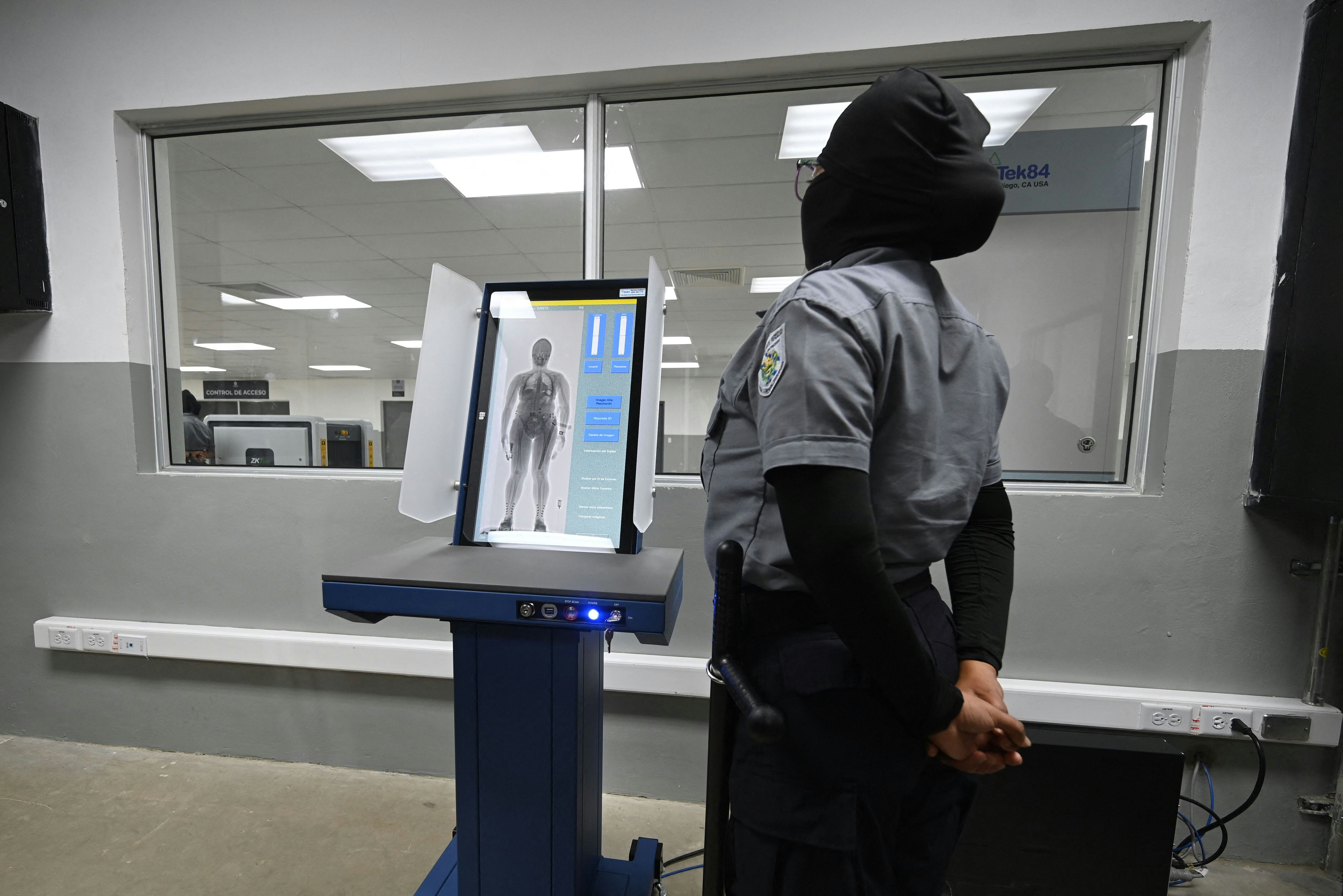 A prison security officer uses a body scanner at the newly inaugurated "Terrorist Confinement Centre...