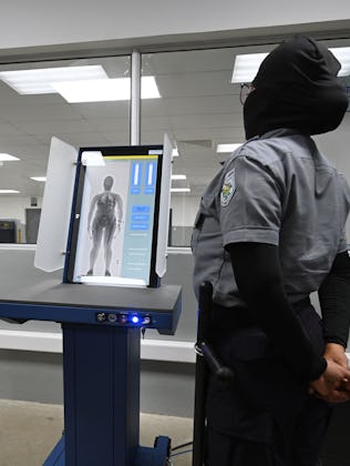 A prison security officer uses a body scanner at the newly inaugurated "Terrorist Confinement Centre...