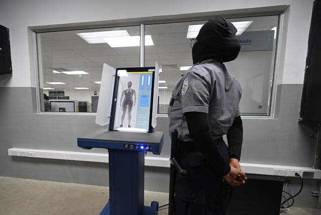 A prison security officer uses a body scanner at the newly inaugurated "Terrorist Confinement Centre...