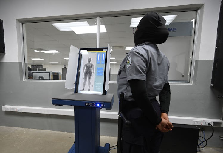 A prison security officer uses a body scanner at the newly inaugurated "Terrorist Confinement Centre...