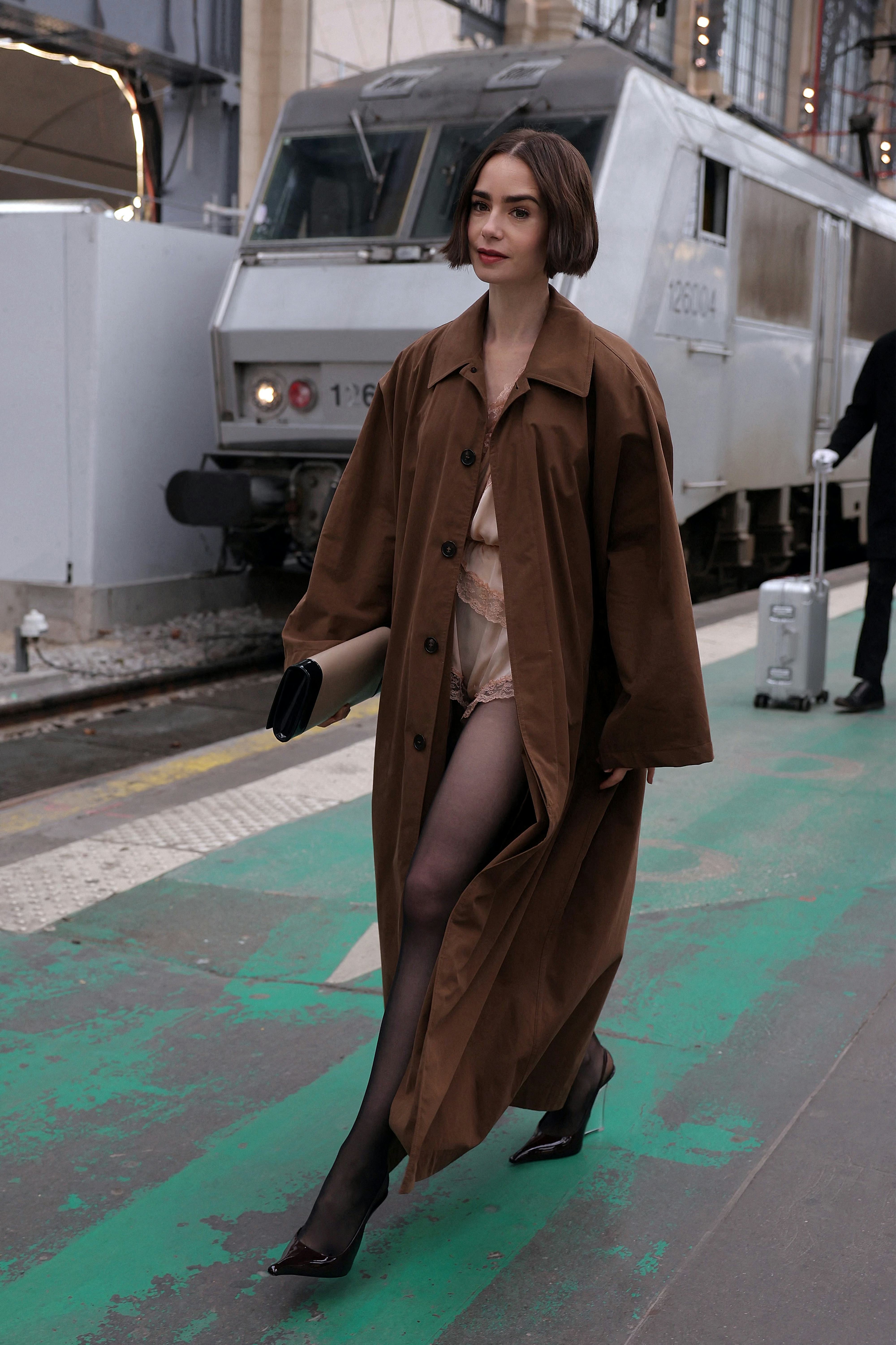 US actress Lily Collins walks on a platform after stepping out of the luxury Orient Express train to...