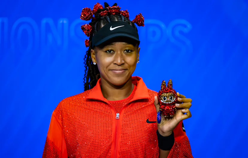 Naomi Osaka poses for a photo with her Labubu after defeating Greet Minnen of Belgium in the first r...
