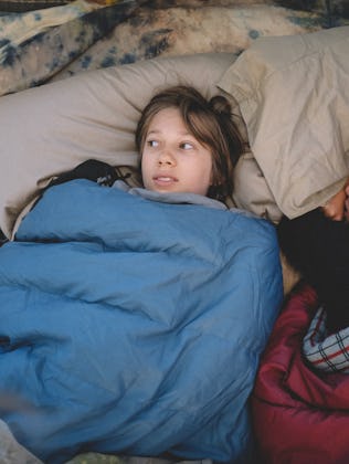 Two boys in sleeping bags at a sleepover.