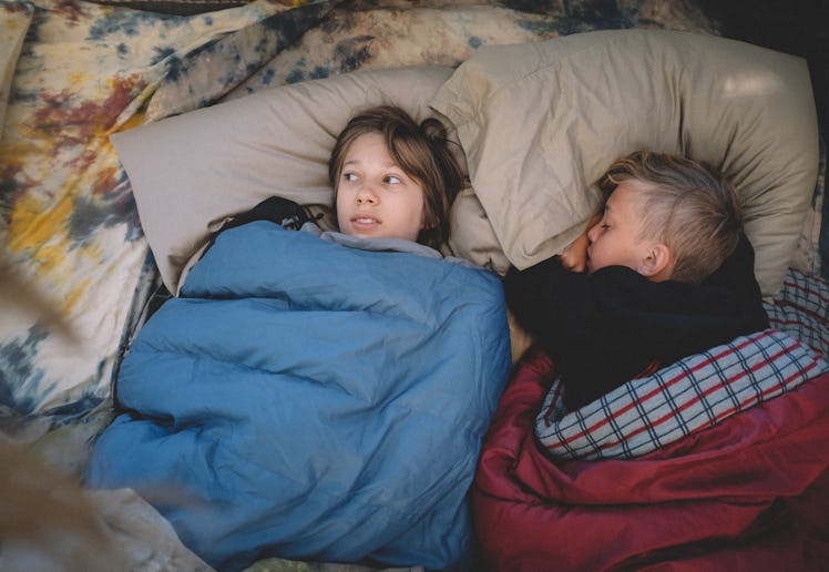 Two boys in sleeping bags at a sleepover.