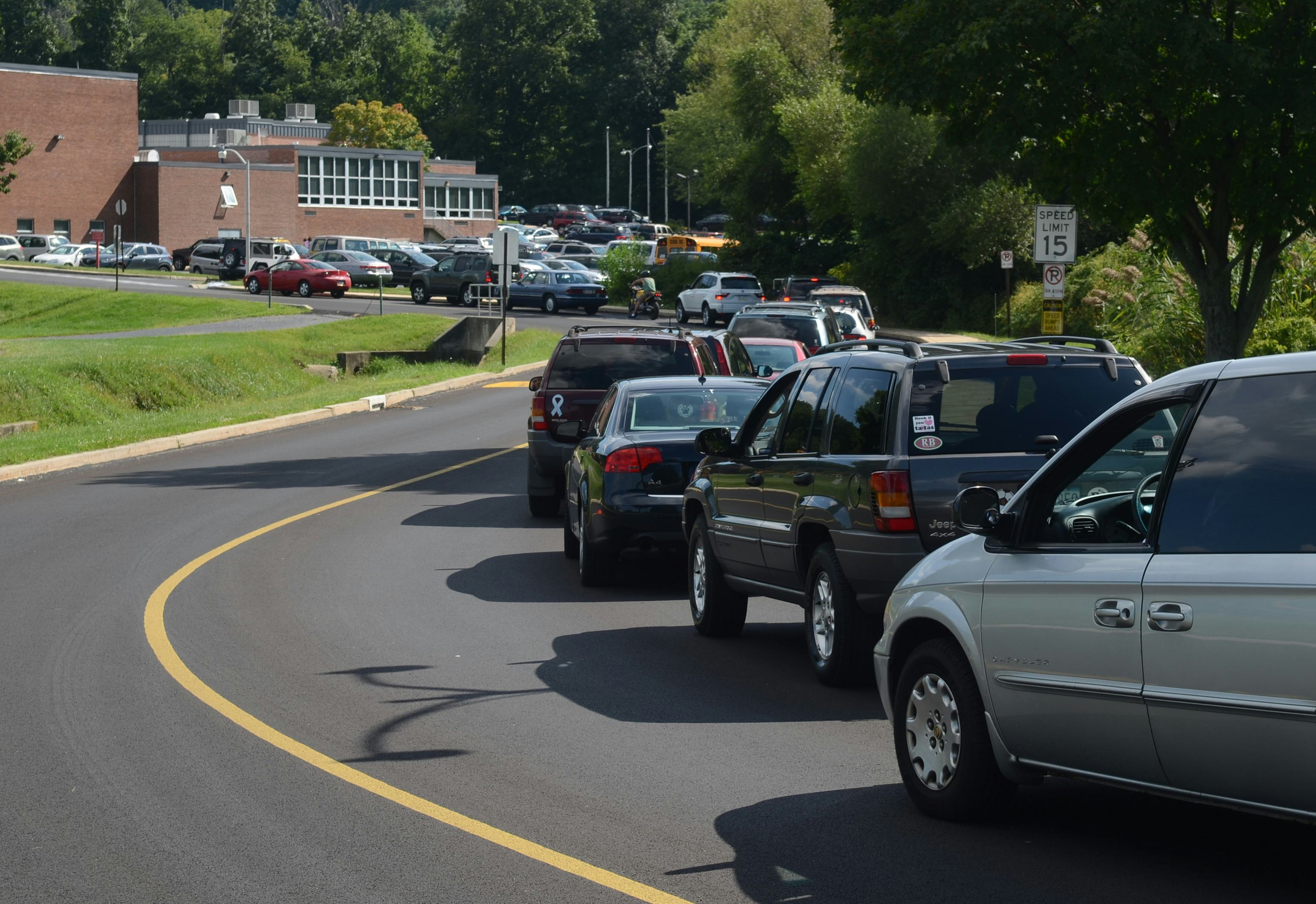 Cars line up to pick up students at the end of the school day. 