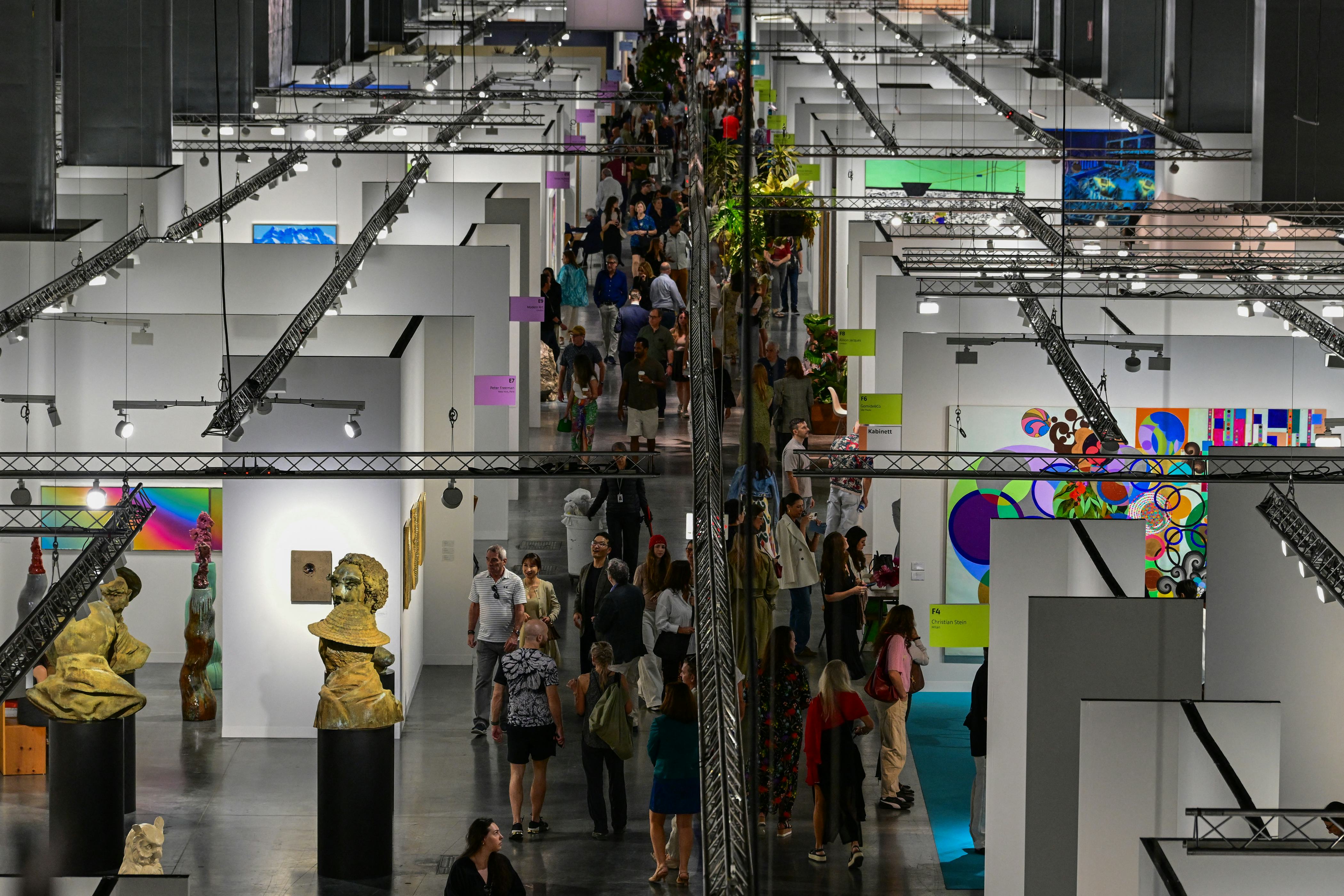 People look at artwork during the 22nd edition of Art Basel at the Convention Center in Miami Beach,...