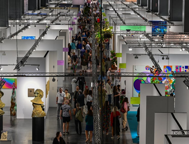People look at artwork during the 22nd edition of Art Basel at the Convention Center in Miami Beach,...