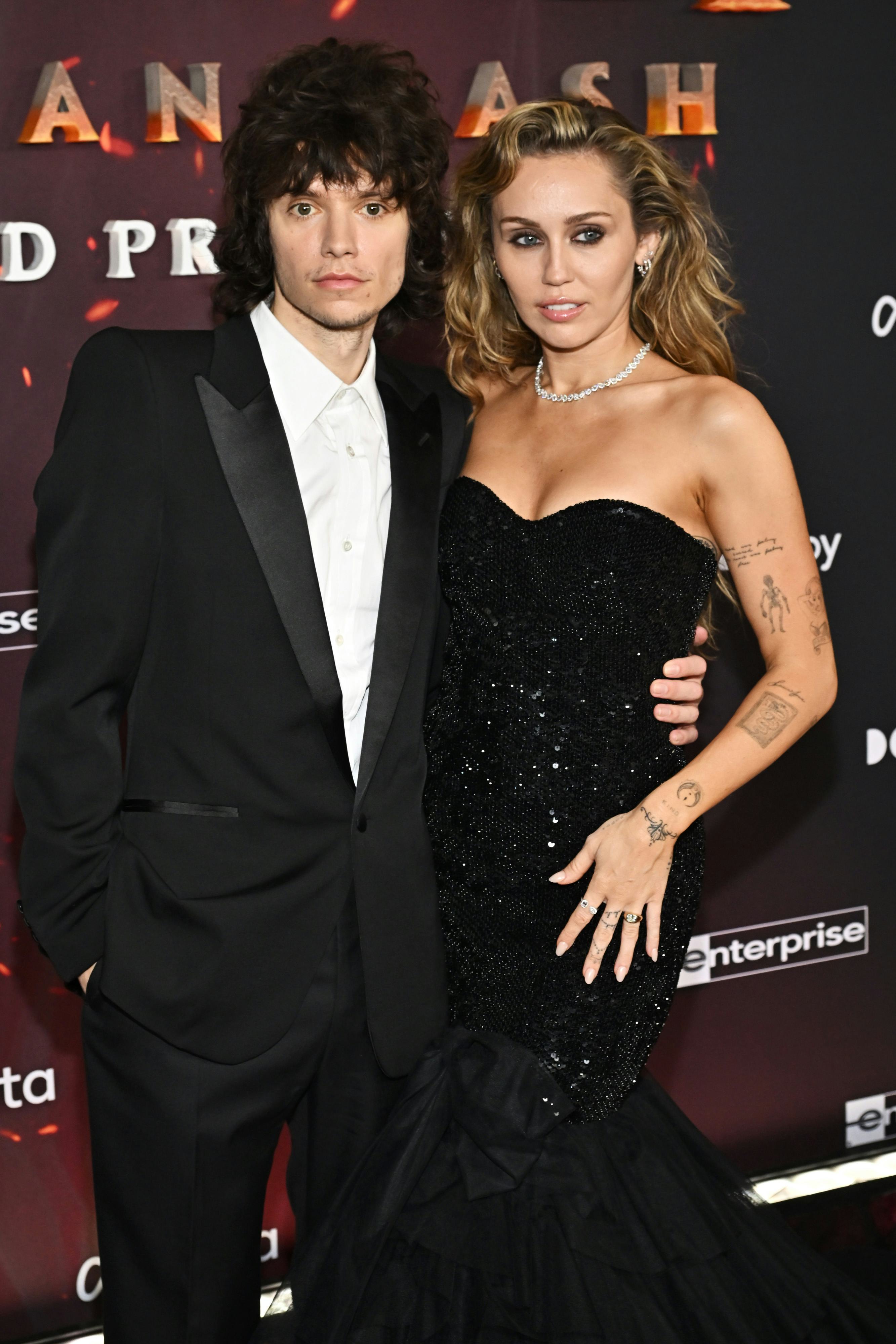Maxx Morando and Miley Cyrus at the "Avatar: Fire and Ash" World Premiere held at the Dolby Theatre ...