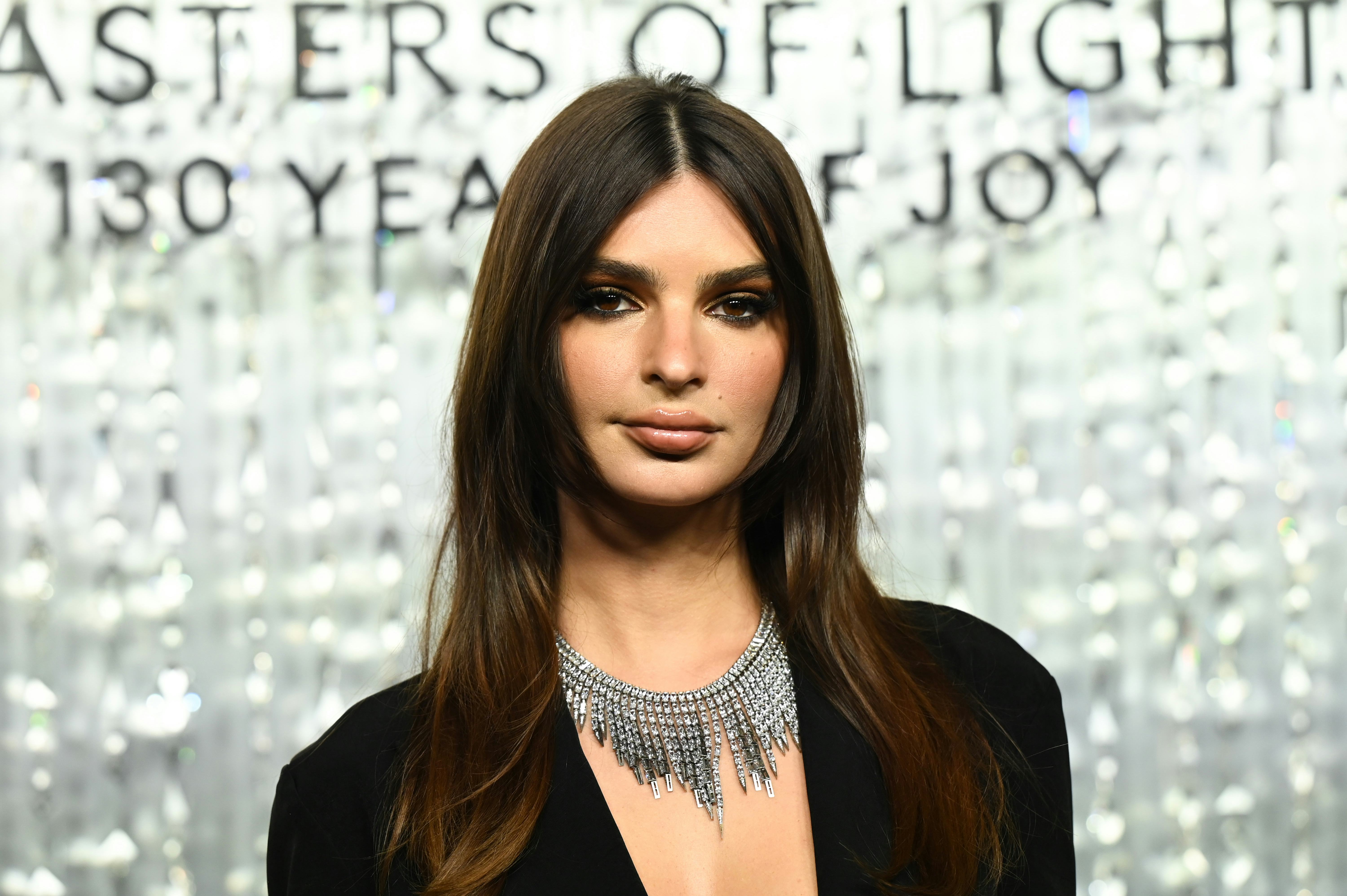 EmRata Decorated Her Christmas Tree While Wearing A "Naughty" Plunging LBD