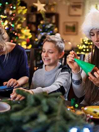 Family making Christmas decorations together at home.Nikon D850.