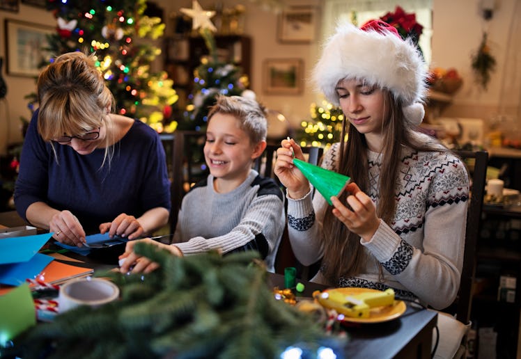 Family making Christmas decorations together at home.Nikon D850.