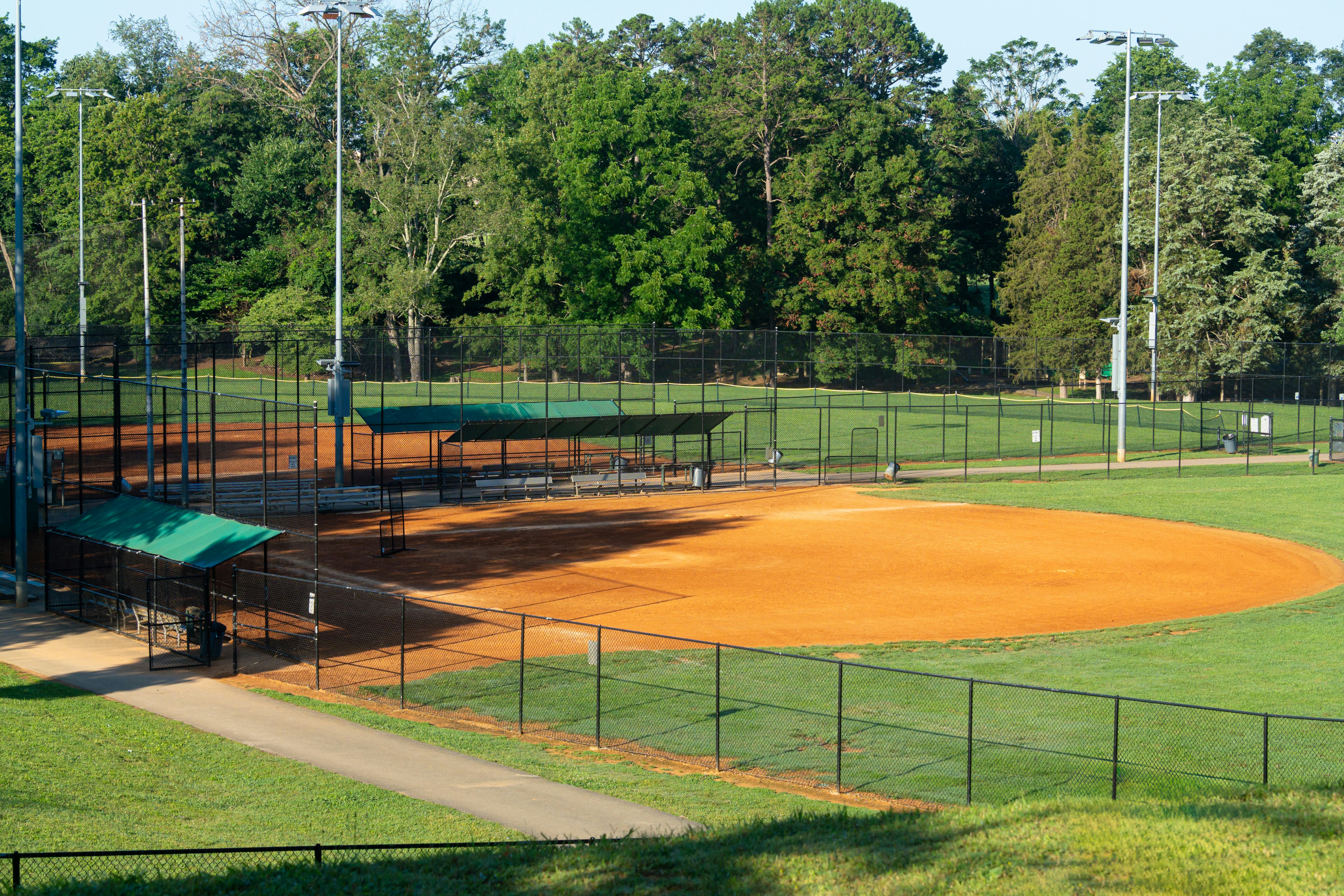 A community public park baseball field on a bright summer day