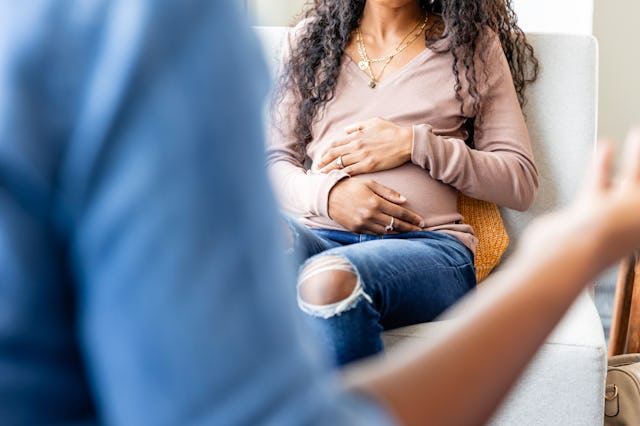 A pregnant woman speaks with a counselor. A new government website in Florida pushes women toward pr...