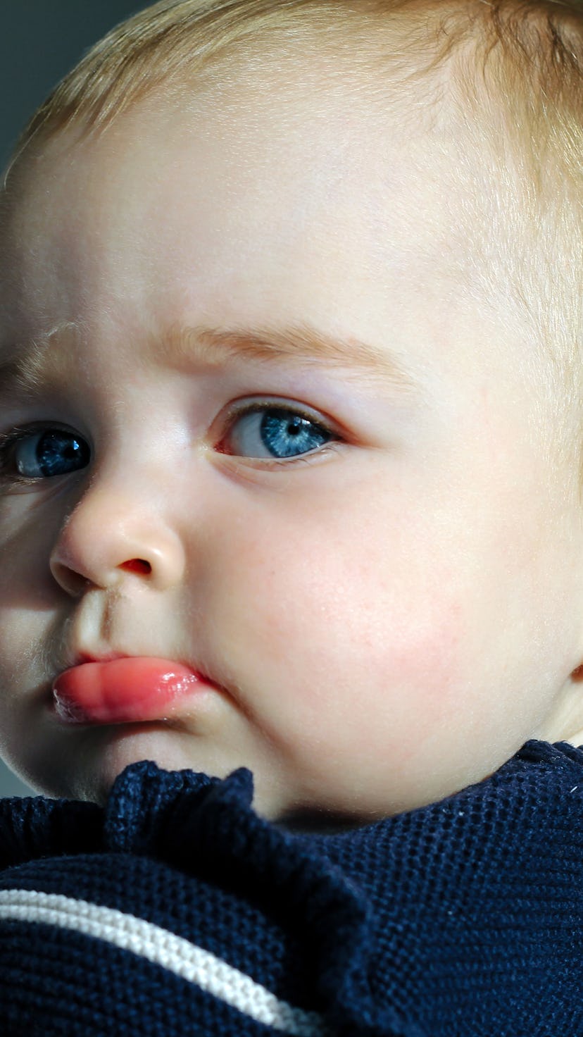 Close up portrait of a sulking baby with a stern look in her face.