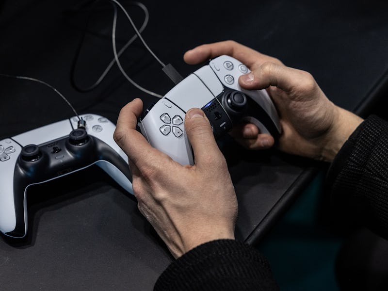 MILAN, ITALY - NOVEMBER 22: A man uses a Playstation gamepad during during Milan Games Week & Cartoo...