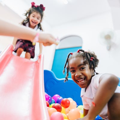 Two girls playing in a ball pit. "Mean girls" might just lack the ability to communicate because of what we teach them as a society.