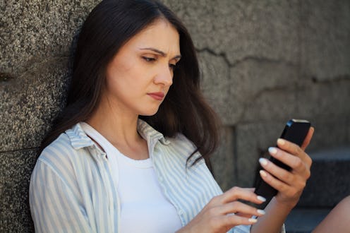 Young woman reading bad news on social media