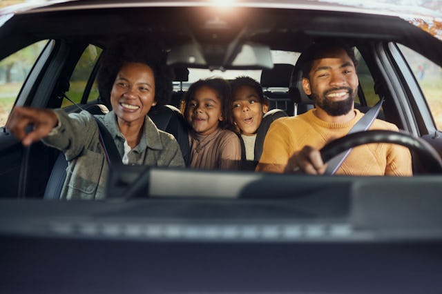 A family in a car going on a sightseeing roadtrip.