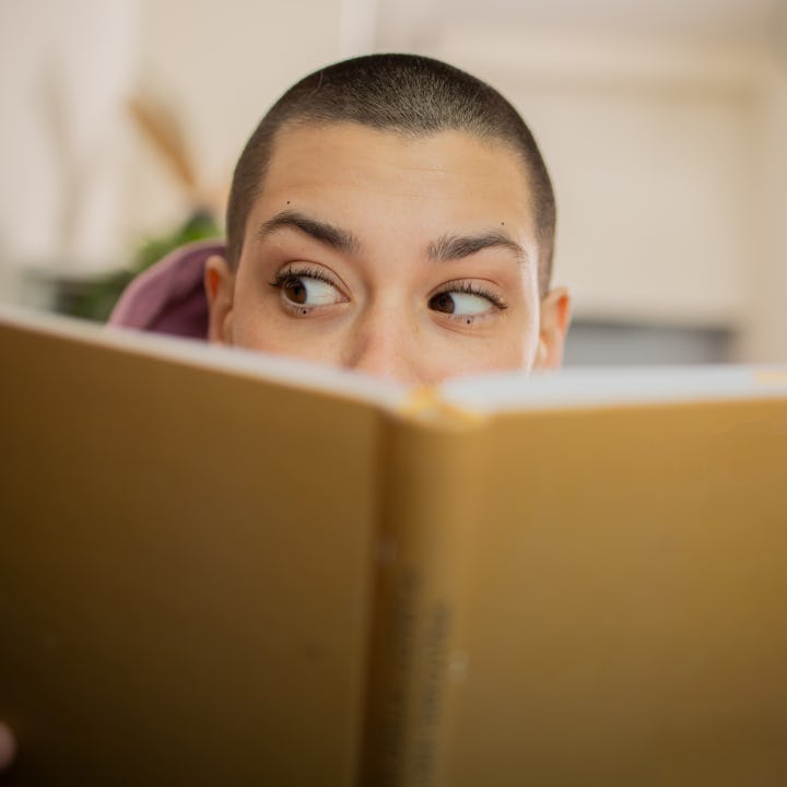 Woman reading a book while relaxing at home