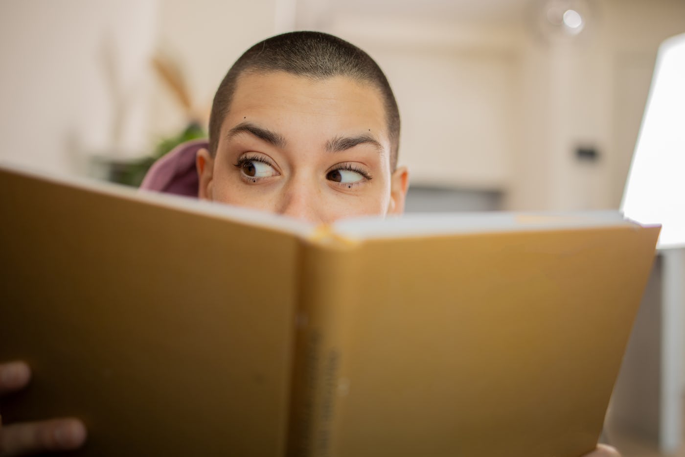 Woman reading a book while relaxing at home