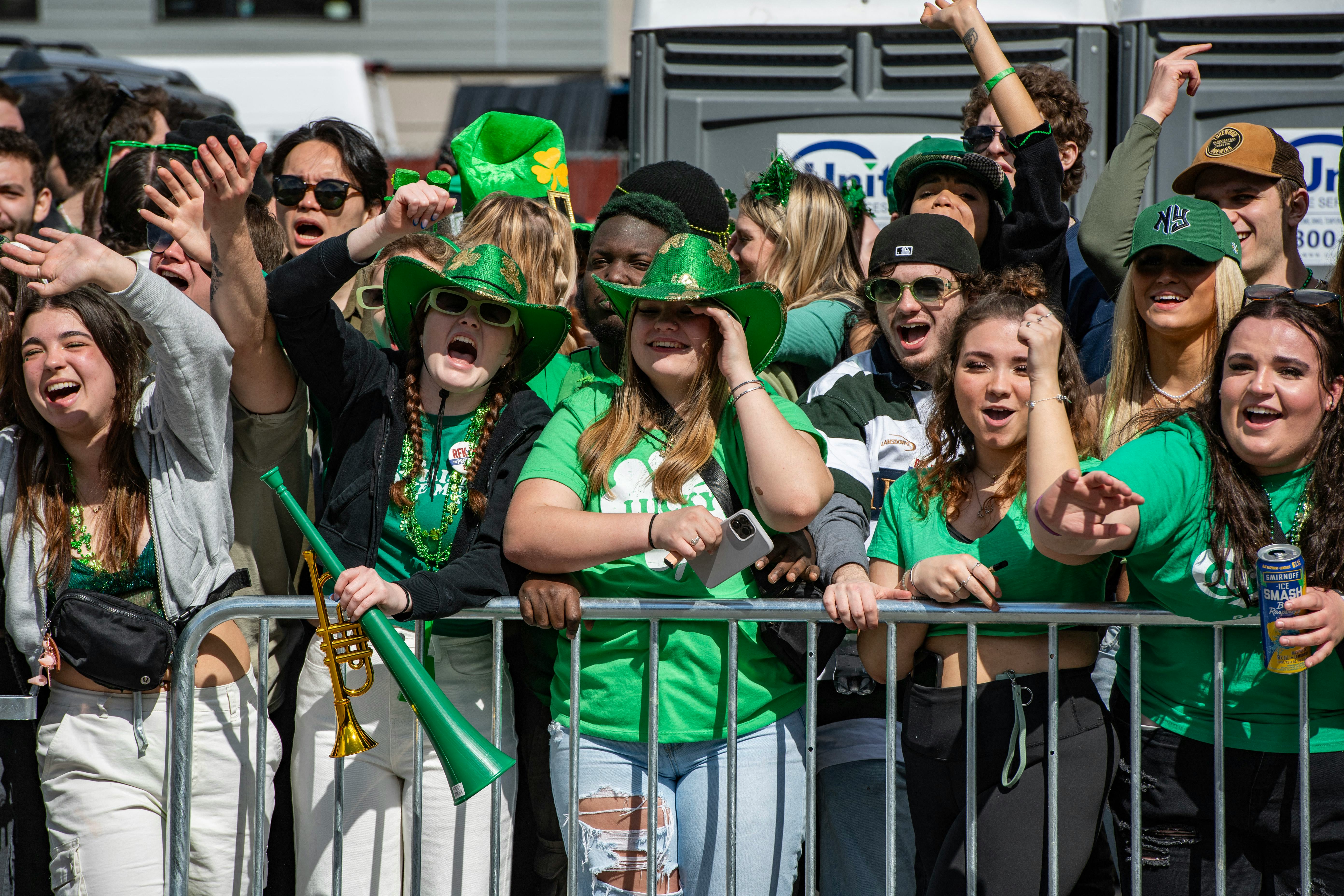 Revelers dressed in green wave during the Boston St. Patrick&rsquo;s Day and Evacuation Day Parade in Bost&hellip;