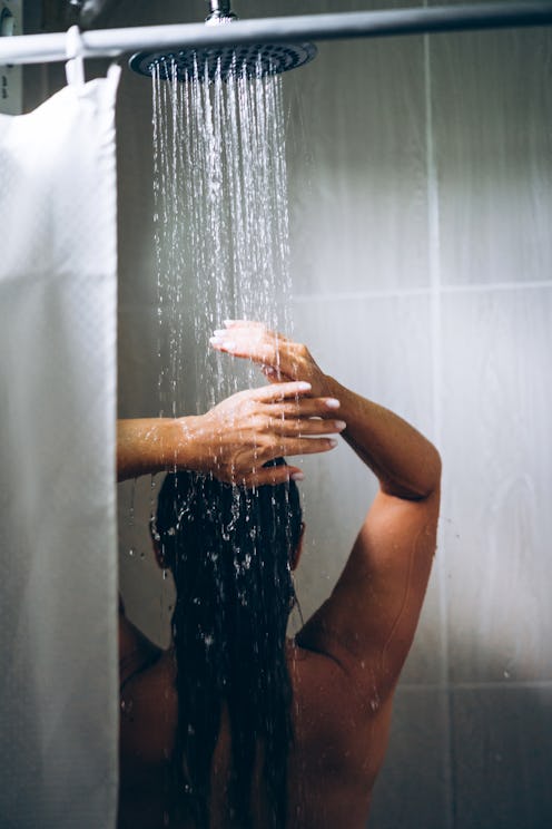 Woman in the hotel room having a shower. Vacation in the tropical resort, morning routine