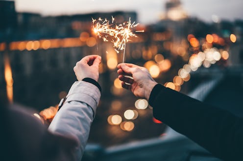 Couple holding sparklers.