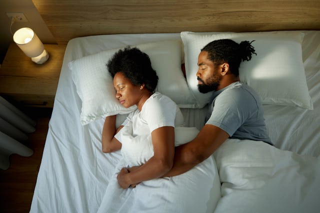 A couple sleeps together in bed. A TikTok user recently asked: where are couples sleeping these days...