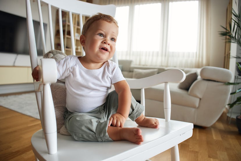 A happy baby boy playing indoors.