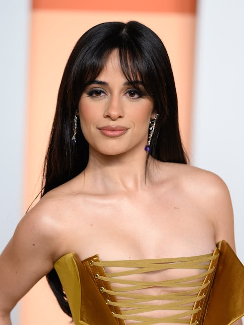 Camila Cabello wore a plunging corp sleaze suit to the Chanel fashion show at Paris Fashion Week.