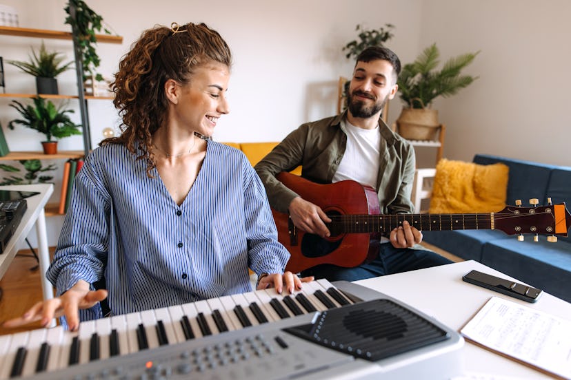 A man and a woman, play guitar and piano