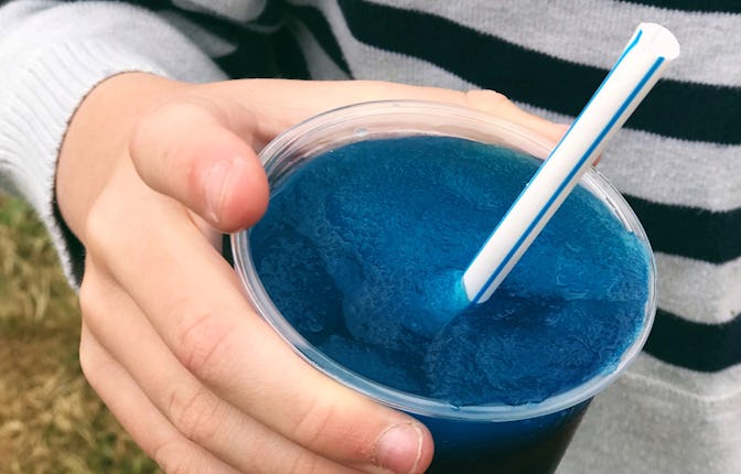 Child hand holding a slushy ice drink