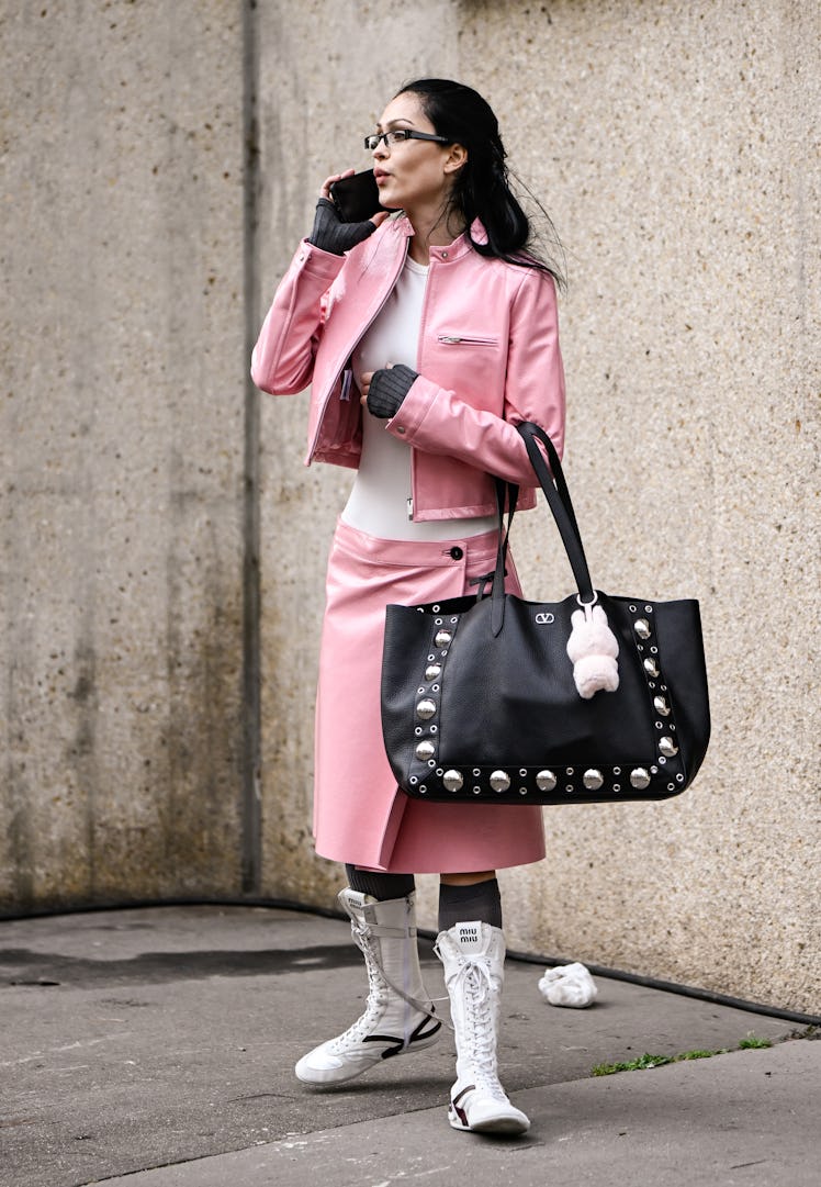 PARIS, FRANCE - MARCH 11: Amelia Gray is seen wearing a pink Miu Miu jacket, white top, pink Miu Miu...