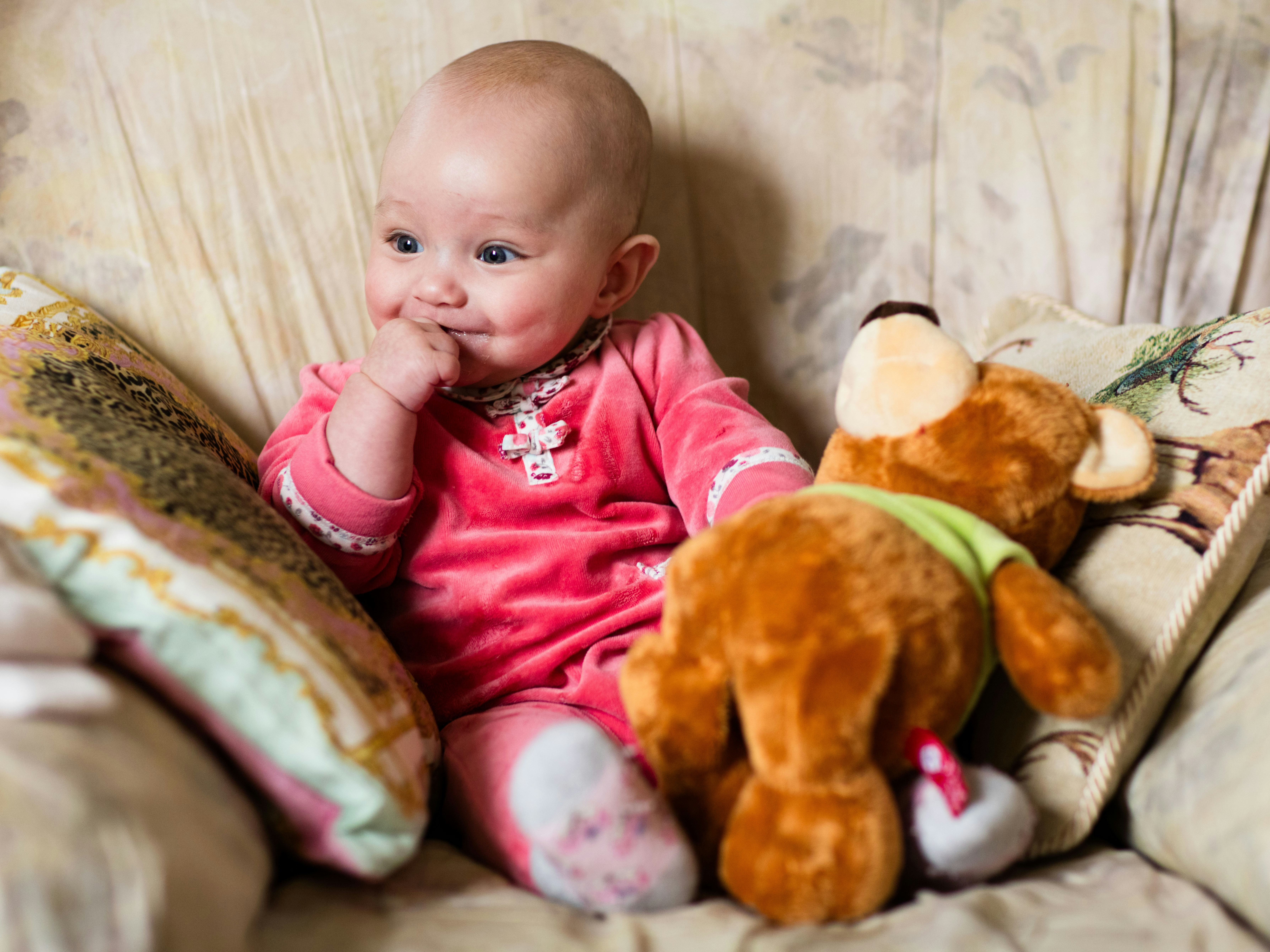 A baby girl with her stuffed animals